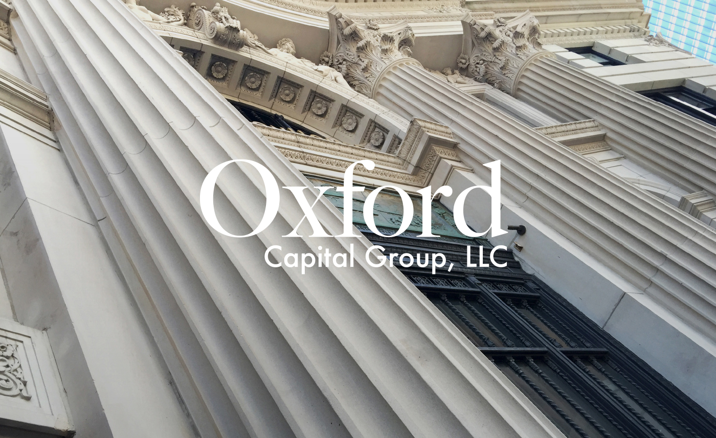 Oxford Capital Group logo overlaid on an image of tall white columns and intricate architecture